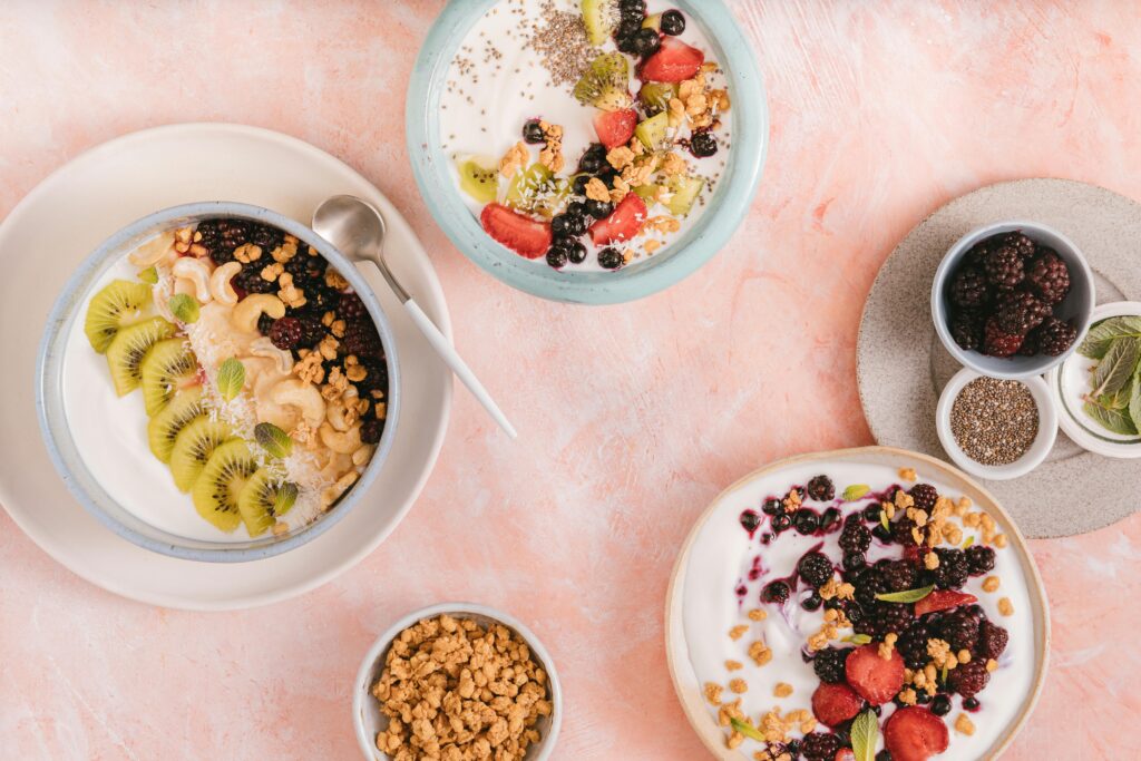 Colorful breakfast bowls filled with yogurt, berries, and granola offer a tasty and nutritious start.