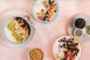 Colorful breakfast bowls filled with yogurt, berries, and granola offer a tasty and nutritious start.